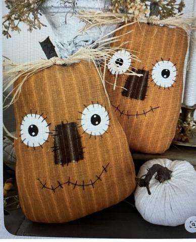 A photo of the planned project, primitive style pumpkin pillows with felt  and straw embellishments.